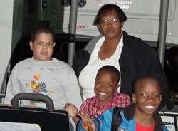 photo of mother with 3 children on bus